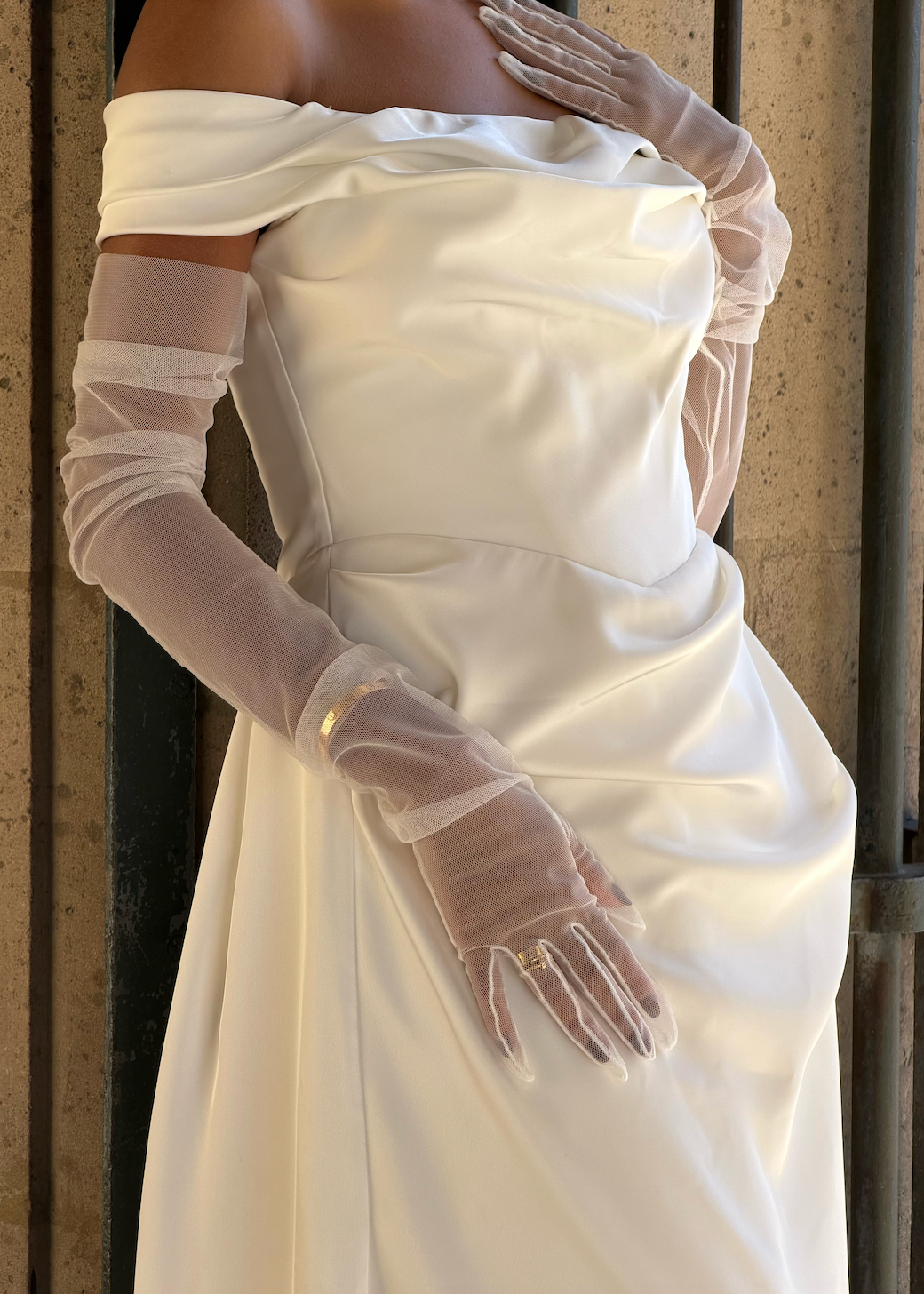 Close-up of the delicate texture and meticulous finish of the removable transparent tulle sleeves.