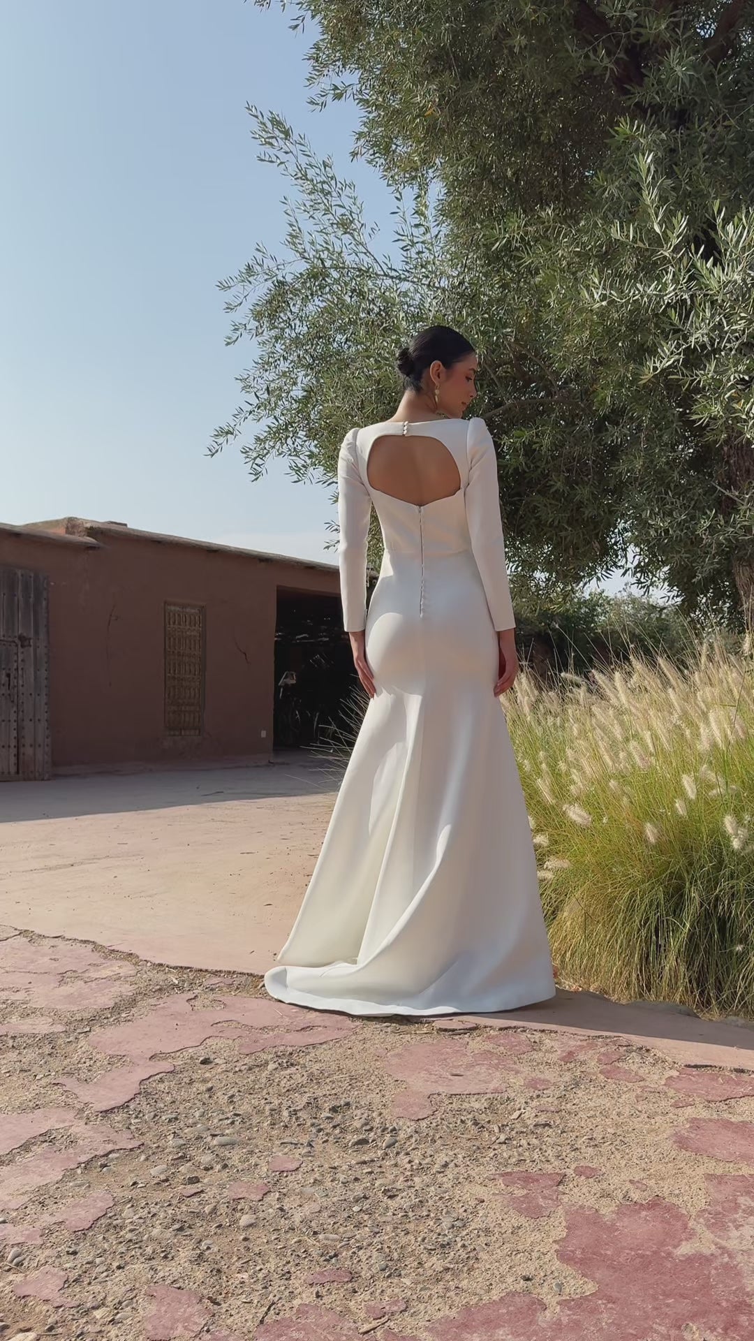 Video of long-sleeved wedding dress with elegant train - moving view and fabric details