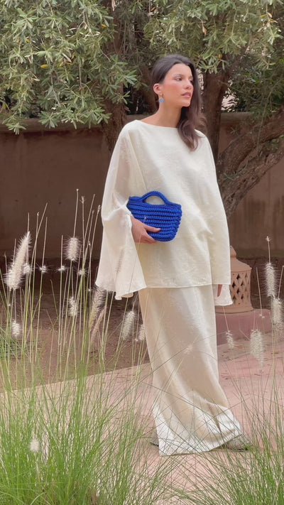Lifestyle video showing the midnight-blue square crochet bag worn by a model, with an urban, artisanal feel