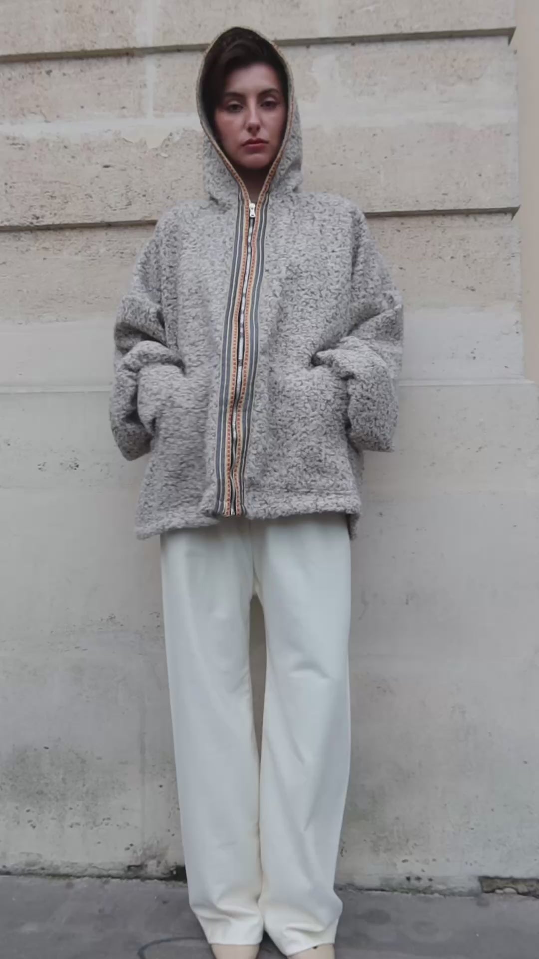 Video showing a beige bouclé wool cardigan with Moroccan sfifas. 