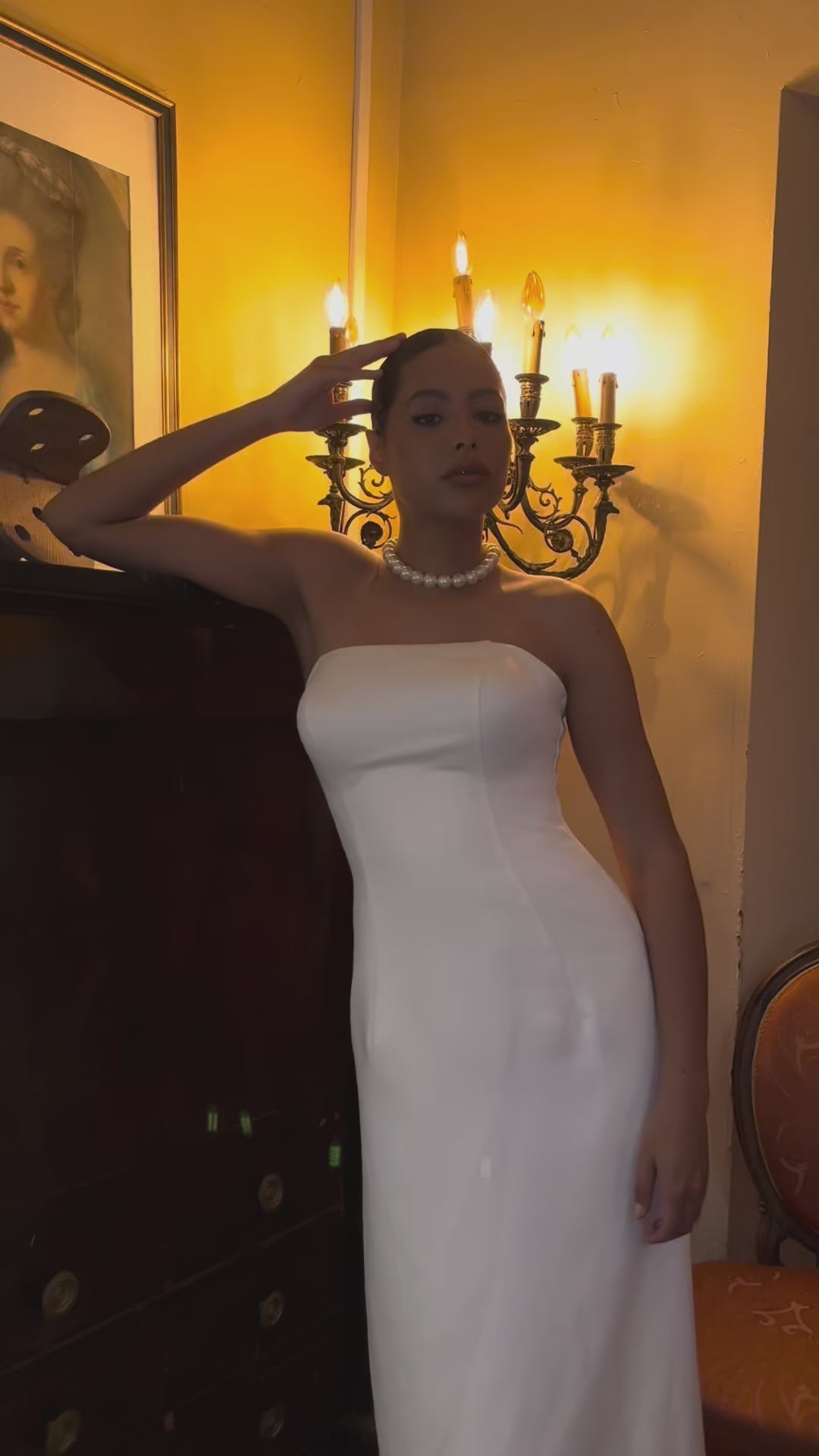 Video of straight strapless wedding dress with light train - moving view highlighting elegant cut and discreet train