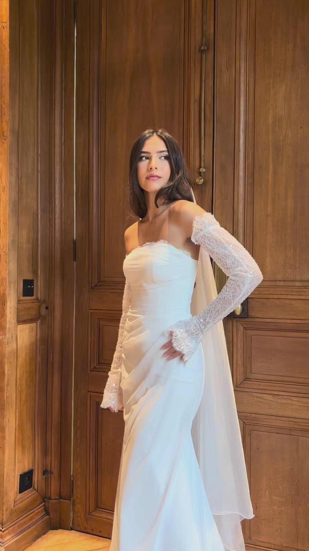 Video of draped strapless mermaid wedding gown with lace detail - moving view highlighting the elegant drape and delicate lace details