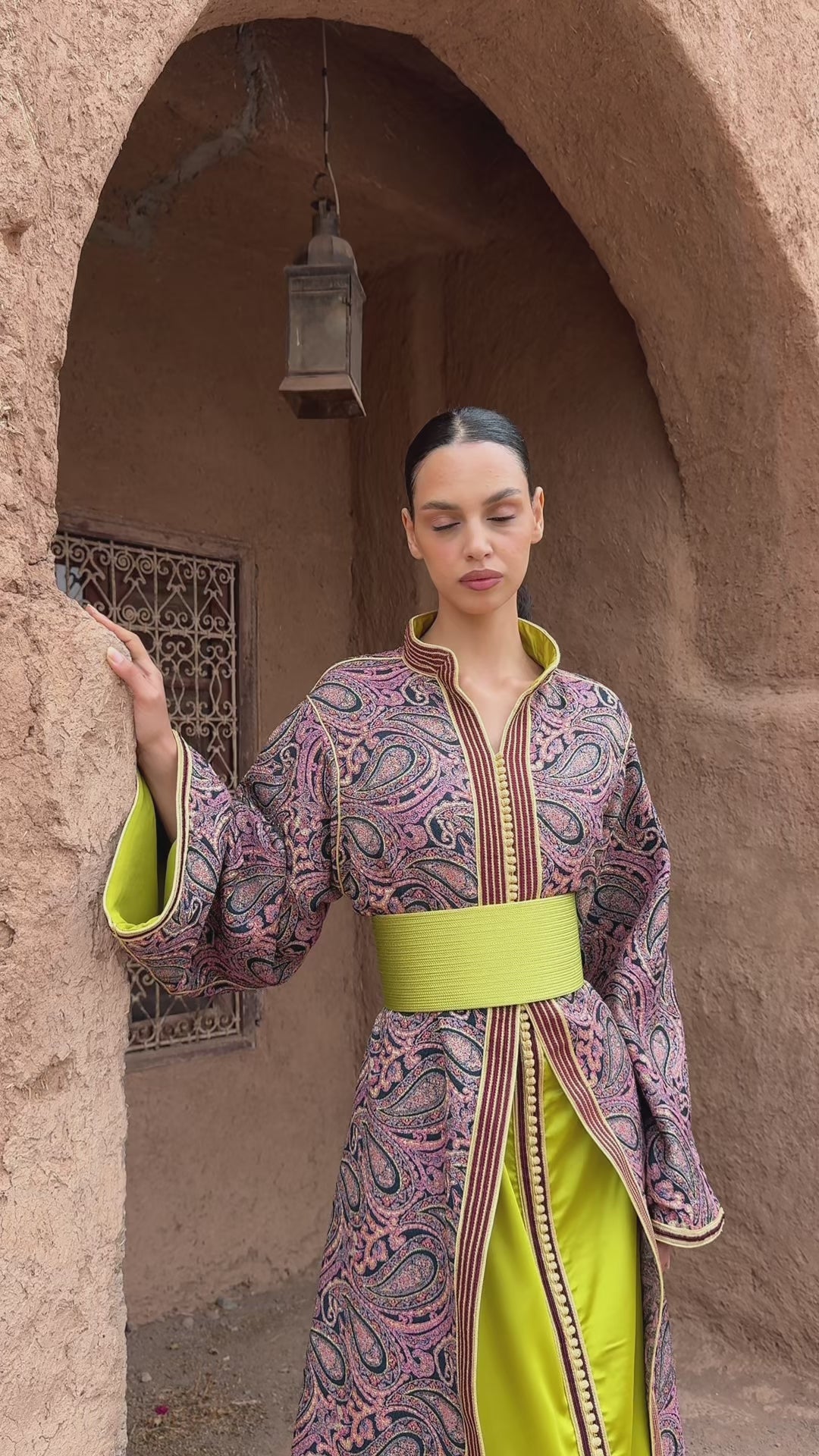Global video showing the burgundy and green brocade collar Kaftan worn in motion