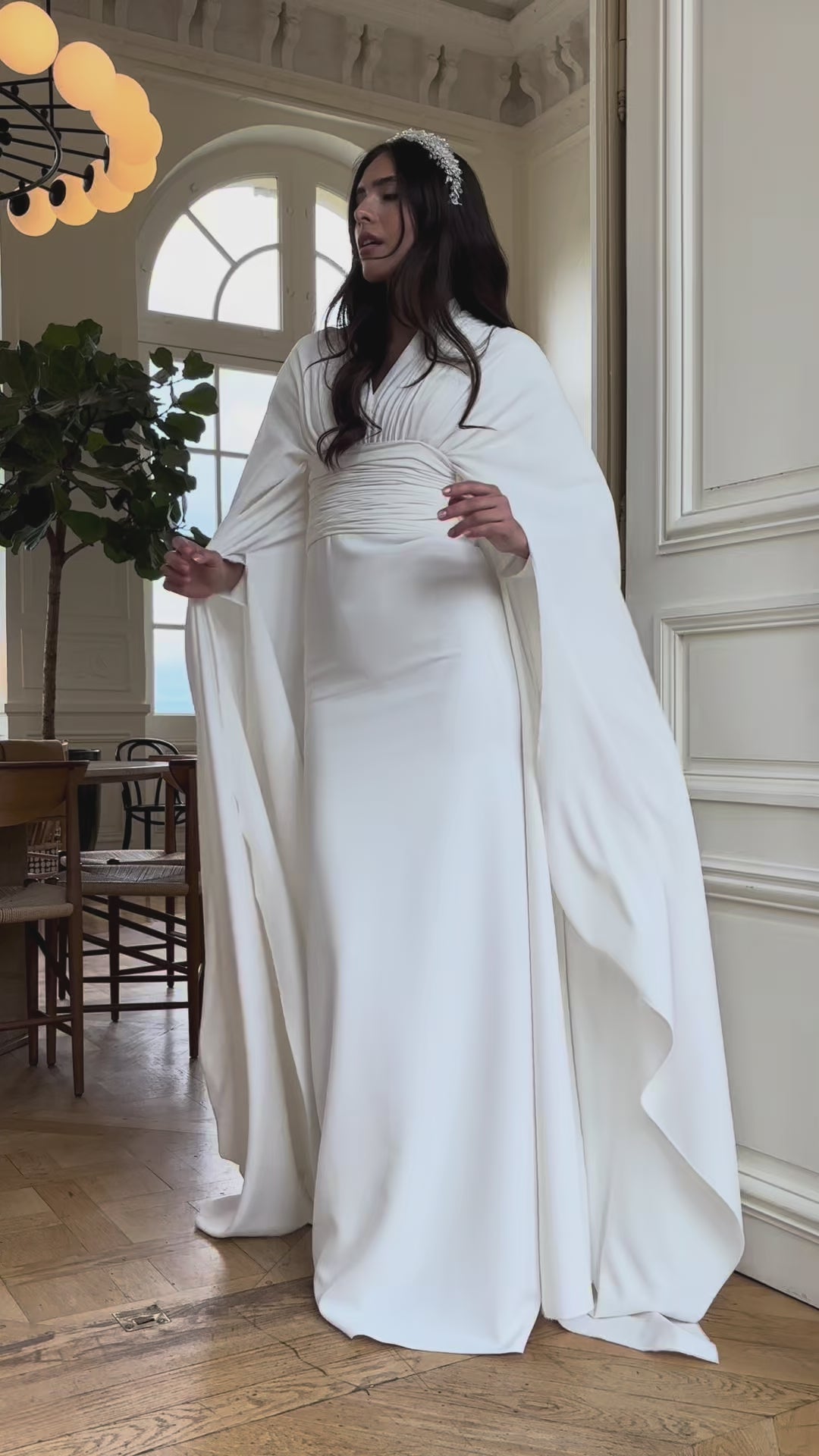 Video of the bohemian chic wedding dress with cape sleeves - moving view highlighting the flowing style and elegant cape sleeves
