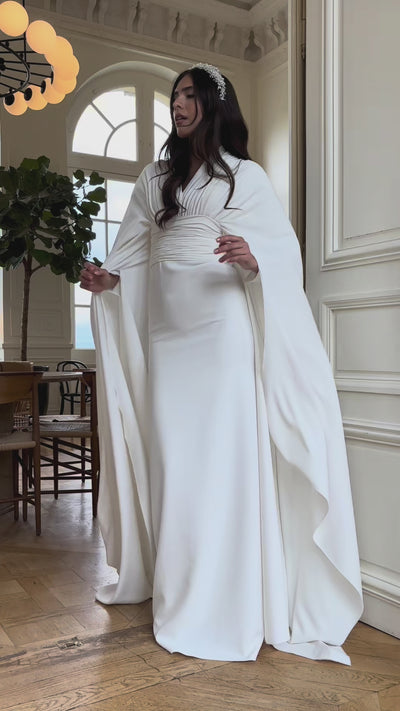 Video of the bohemian chic wedding dress with cape sleeves - moving view highlighting the flowing style and elegant cape sleeves