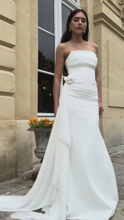 Video of draped mermaid wedding gown with removable flower - moving view featuring elegant drape and decorative removable flower