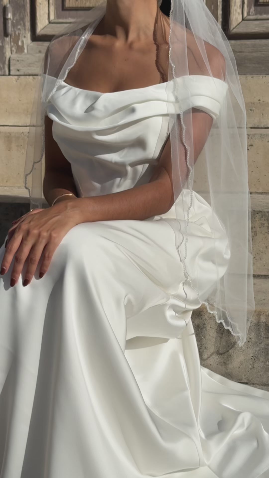 Video of short tulle bridal veil with wavy finish, shown front, back, profile and worn in situation