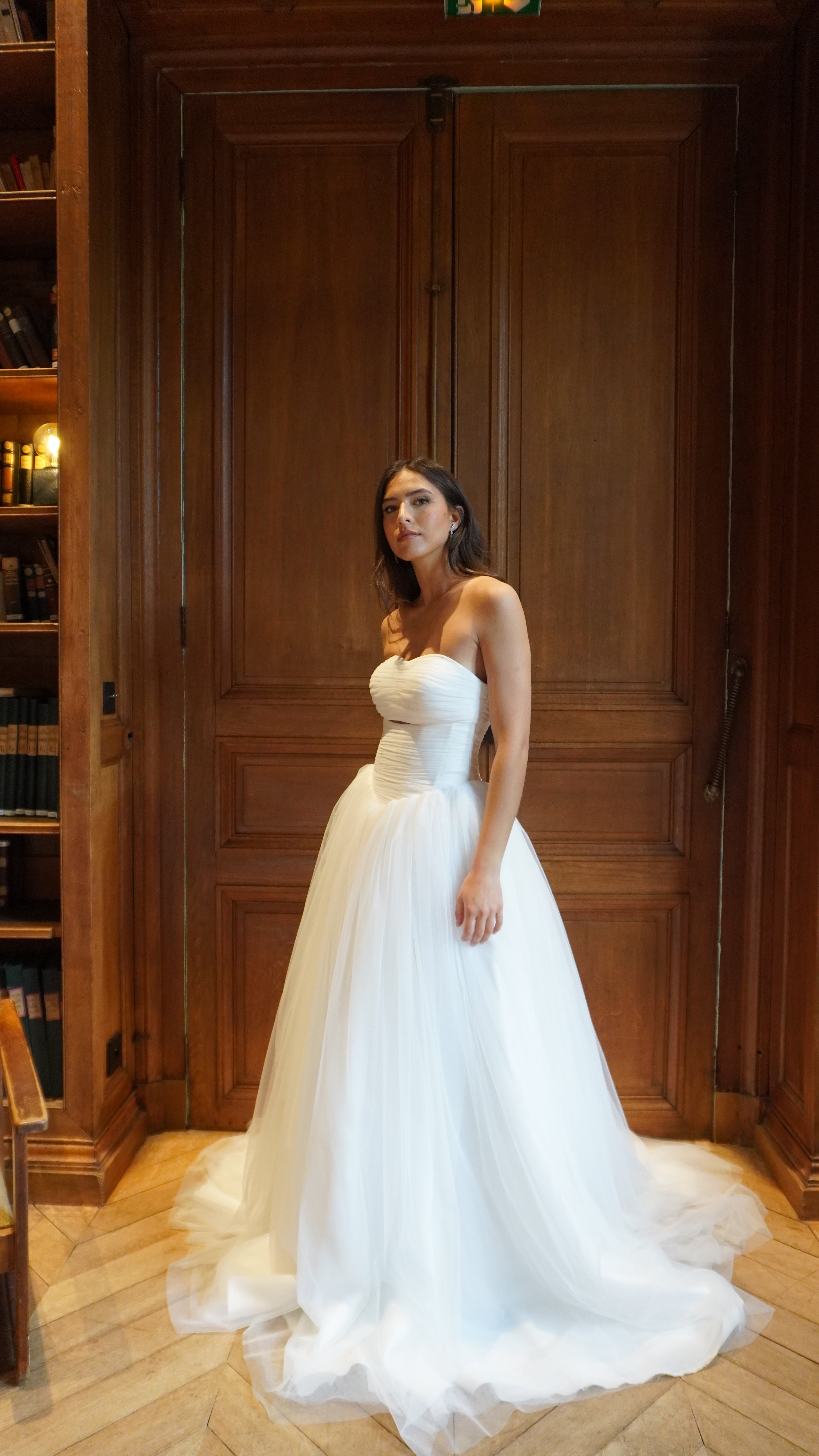 Strapless tulle princess wedding gown captured in motion, highlighting the lightness of the tulle and the airy volume of the skirt.